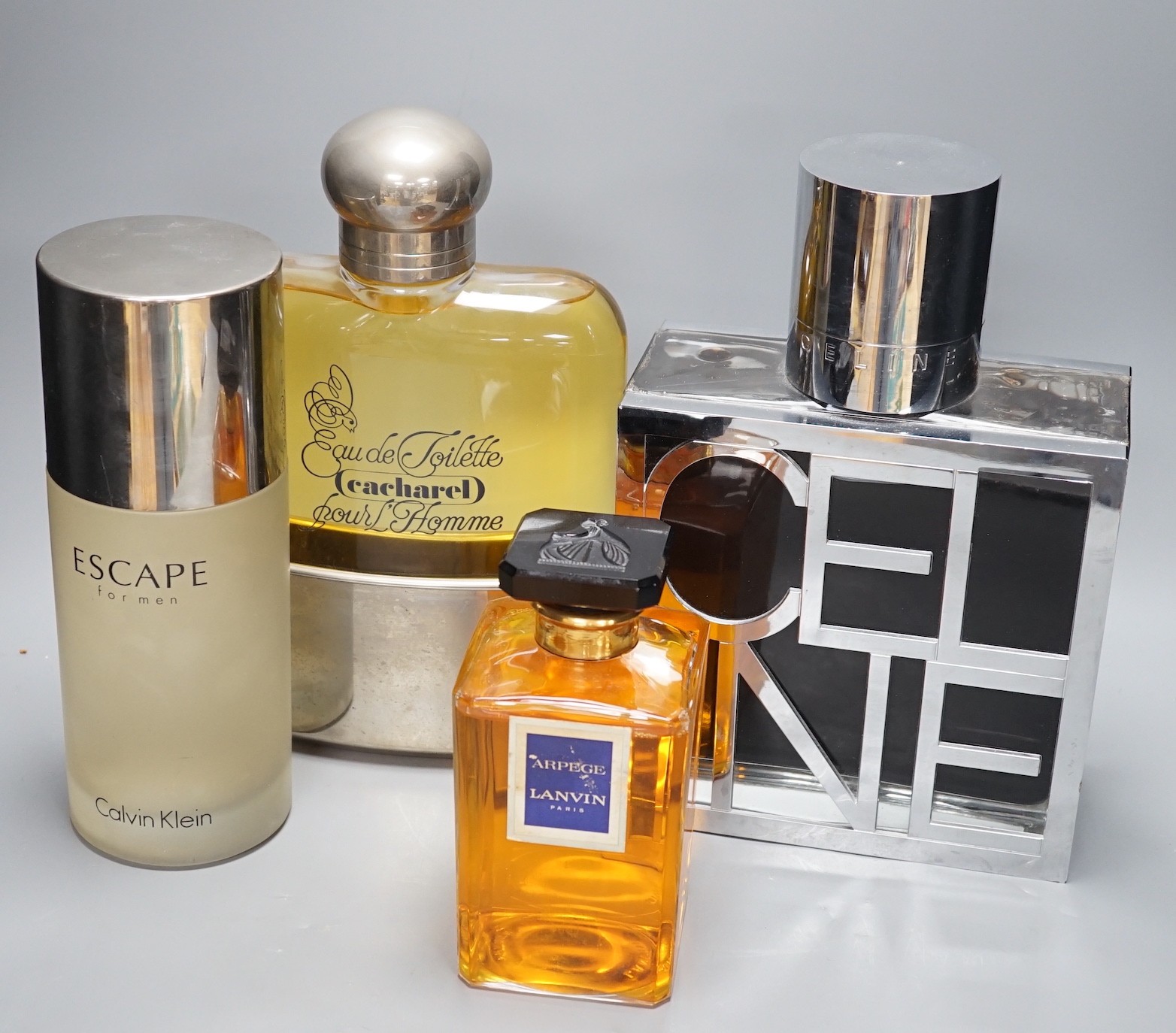Oversized advertising perfume display bottles including Celine, Cacharel pour Homme, Arpege Lavin and a Calvin Klein perfume bottle (4), tallest Celina 33 cms high